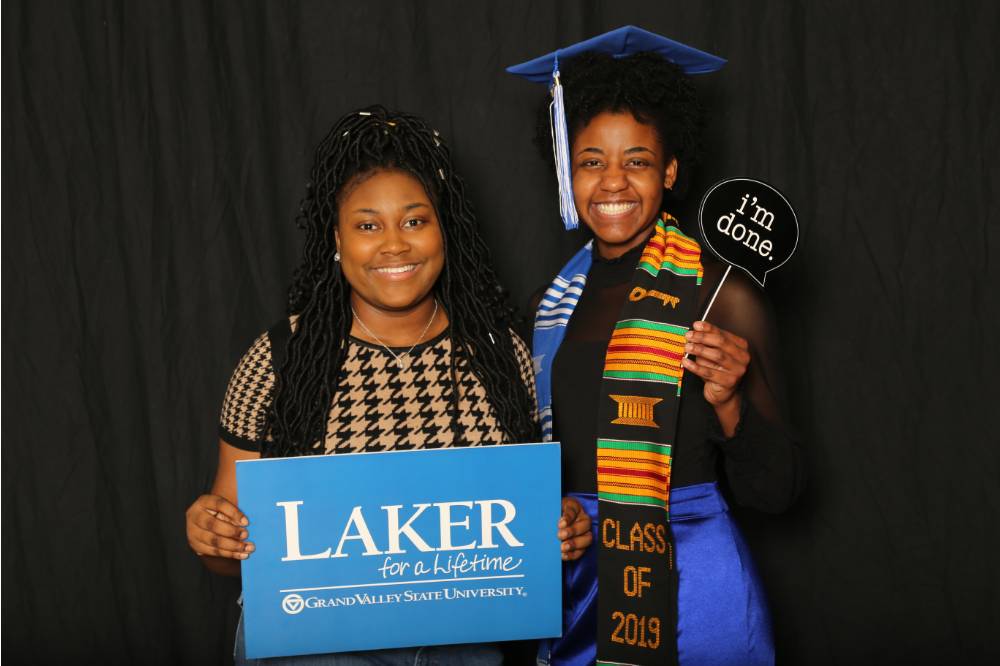 two students holding props for a picture